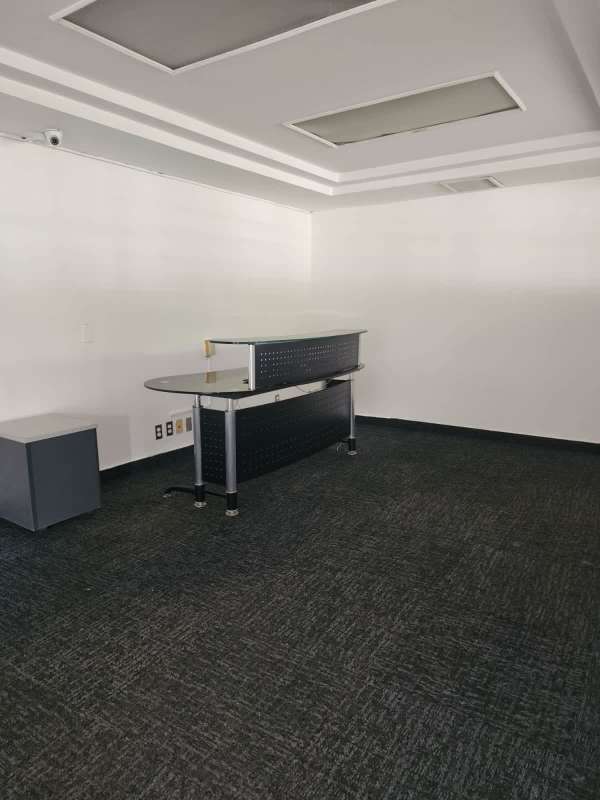Minimalist commercial office reception with modern desk, carpet flooring at Urbanización La Boca Ancón