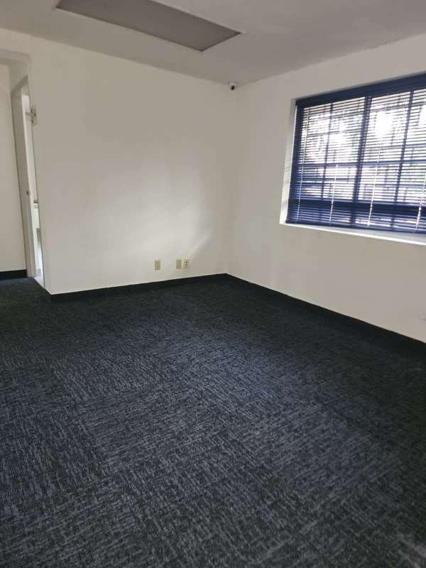 Empty spacious tiled office room with white walls available for rent Ancón La Boca Panama