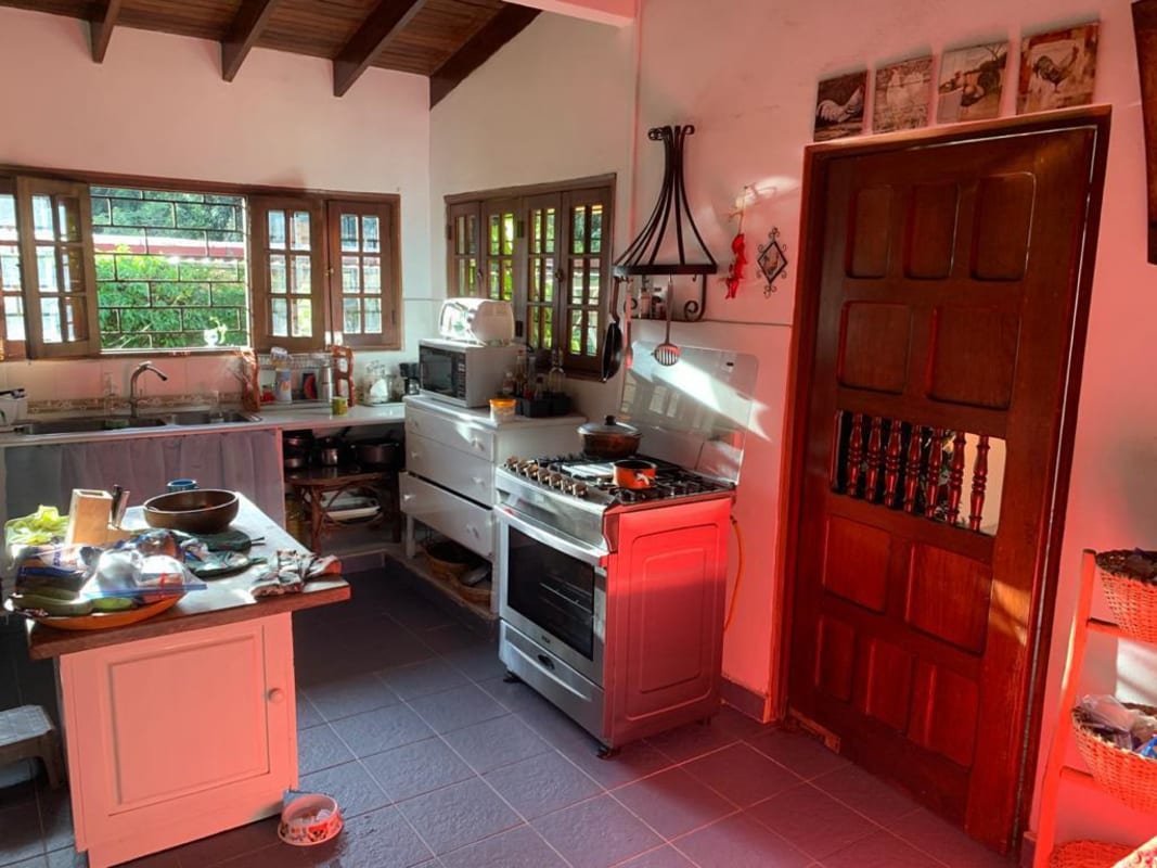 Bright sunroom with floor-to-ceiling windows wood paneling in Las Cumbres Panama house