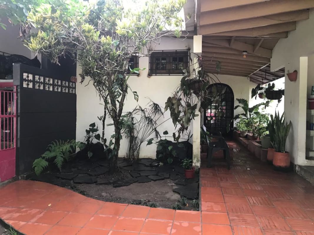 Bright rustic kitchen with wooden beams island and natural light in house for sale Panama