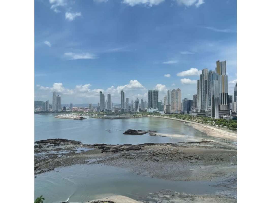 Traditional luxury living room with marble floors, chandelier and large windows ocean view at PH Peninsula Punta Paitilla