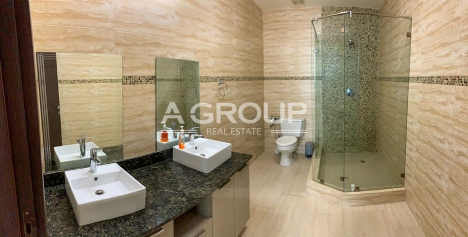 Luxury bathroom with double sink, glass shower enclosure, marble counters in Grand Tower Punta Pacífica