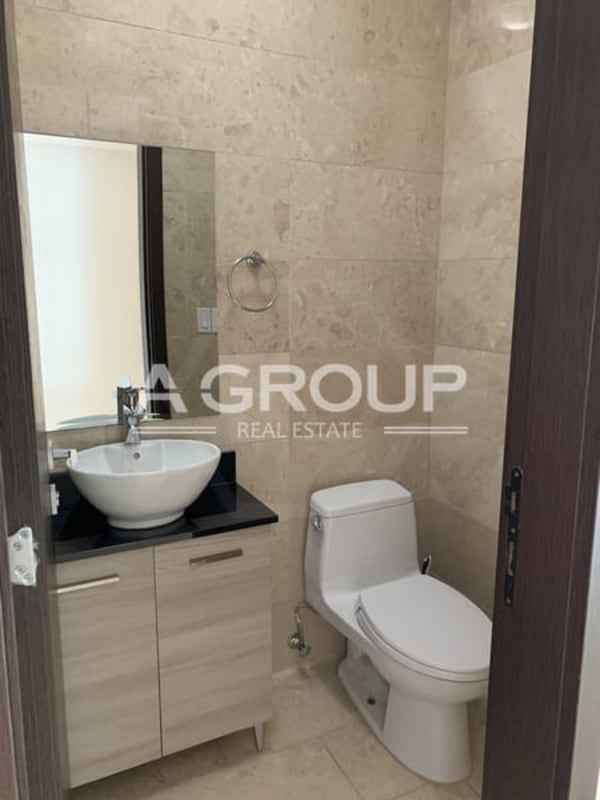 Minimalist hallway with staircase connecting duplex floor levels in Grand Tower Punta Pacífica