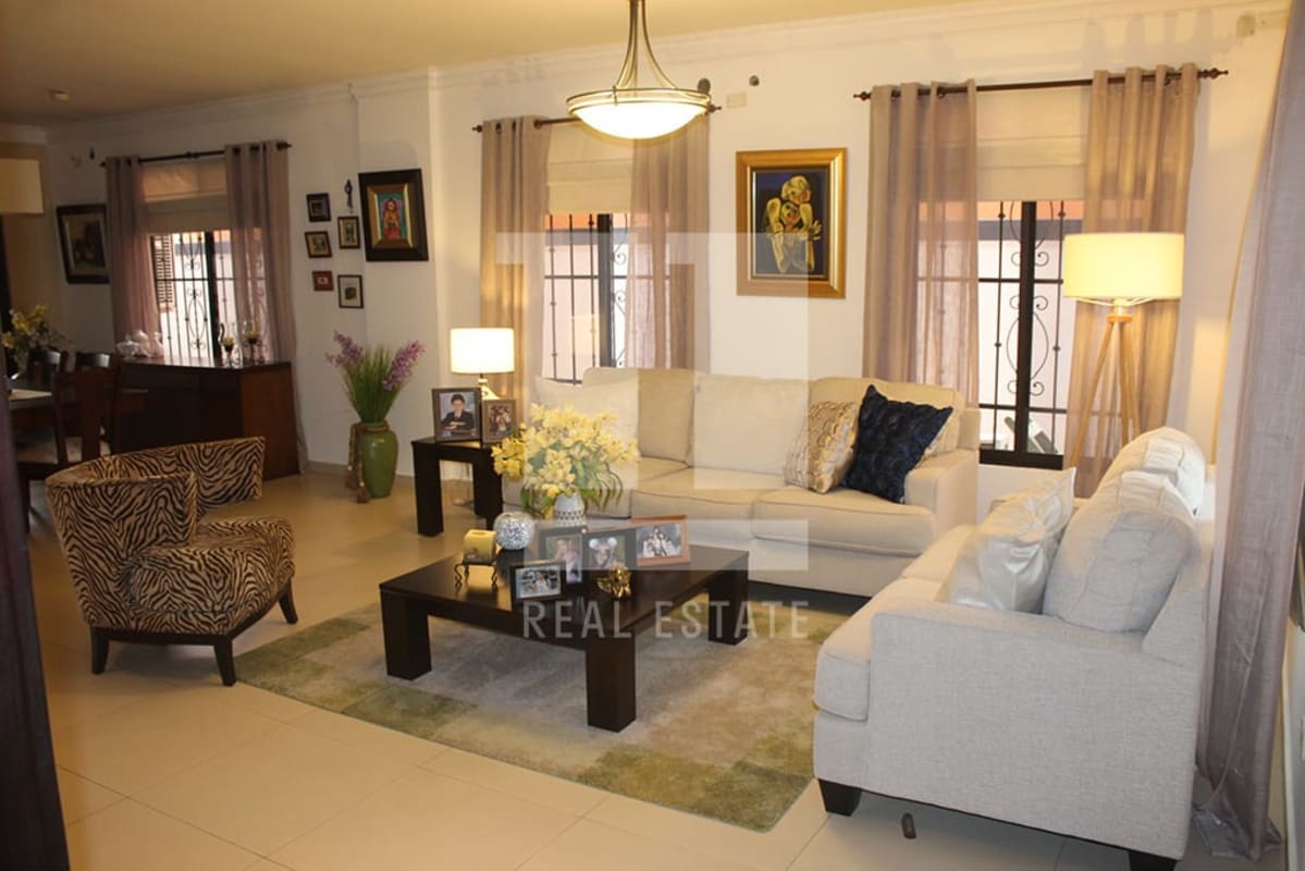 Dining area with wooden furniture and decorative wrought iron doors in Altos de Panamá home