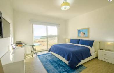 Bedroom with large windows ocean view balcony Casamar Marinazul condo Panama