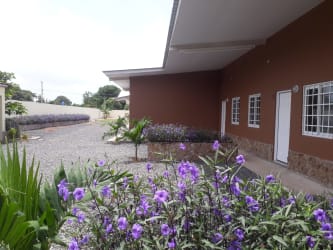 View of PH Rincon del Paraiso apartment building exterior with garden and parking in Antón Panama