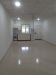 Kitchenette with cabinets, stove, refrigerator inside studio apartment PH Rincon del Paraiso Rio Hato Panama