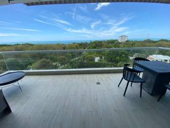 Aerial shot beachfront condo PH Solea lush greenery ocean horizon Punta Barco Panama