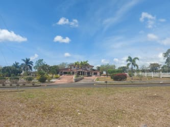 Sample home and landscaped entrance at Boquete Canyon Village residential project Panama