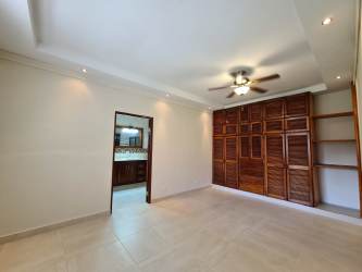 Large master bedroom with wood closet, tiled floors, ceiling fan in Santa Clara house Panama