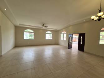 Traditional kitchen with granite countertops, island, wood cabinetry in Santa Clara new home Panama