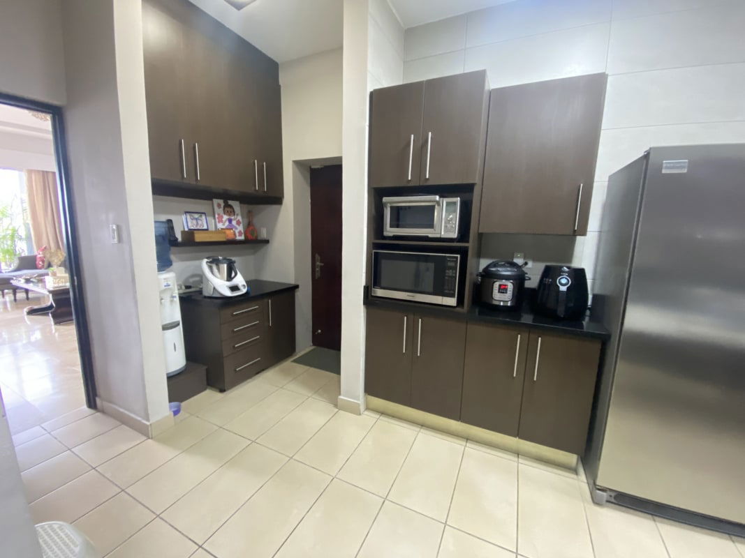 Luxury dining area with chandelier, marble flooring, open layout PH Pacific Coast San Francisco Panama apartment