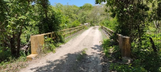 Rural dirt bridge crossing natural greenery near Panama beachfront estate