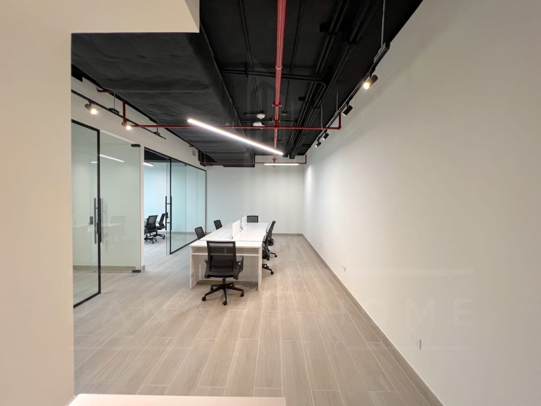 Kitchenette area with large city view window inside office at Tower Bank