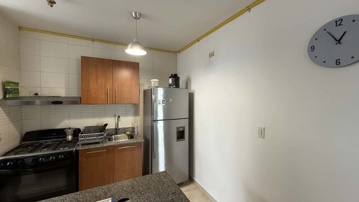 Contemporary kitchen with granite countertop, gas stove, stainless steel fridge PH Vitro Tower Panama City