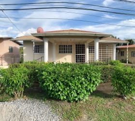 House entrance with columns, porch, landscaped yard in Colinas de Santa Isabel David Panama