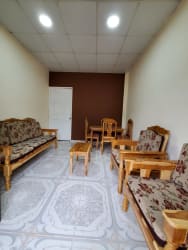 Basic kitchenette with stainless sink, tiled backsplash, security bars in Aguadulce investment property for sale