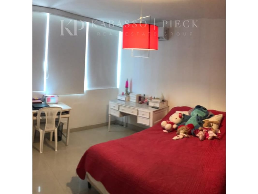 Contemporary bedroom with red bedding workspace large windows Vista del Sol Paitilla