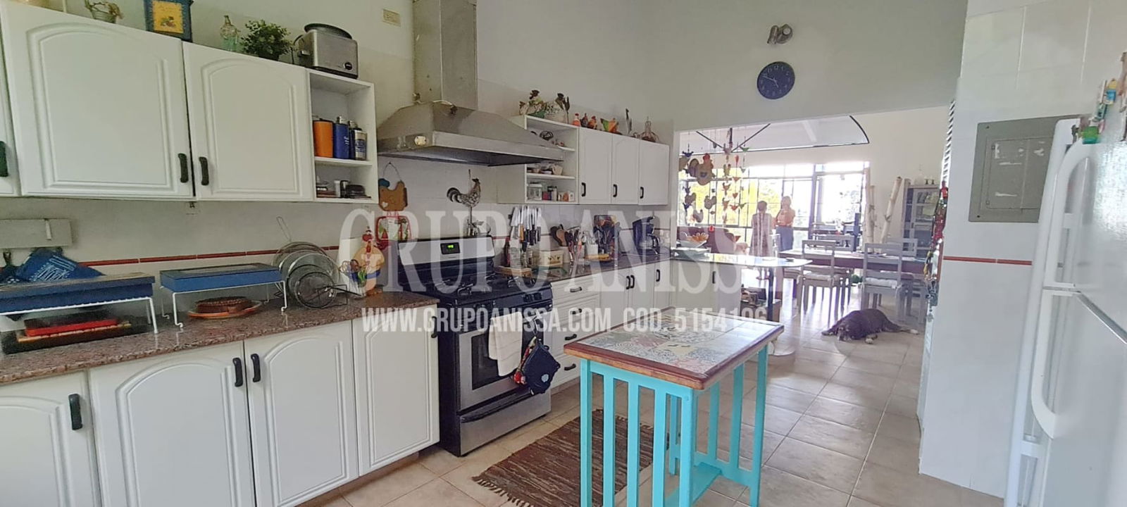 Mountain cabin style kitchen with granite counters, traditional cabinets, large window with garden view