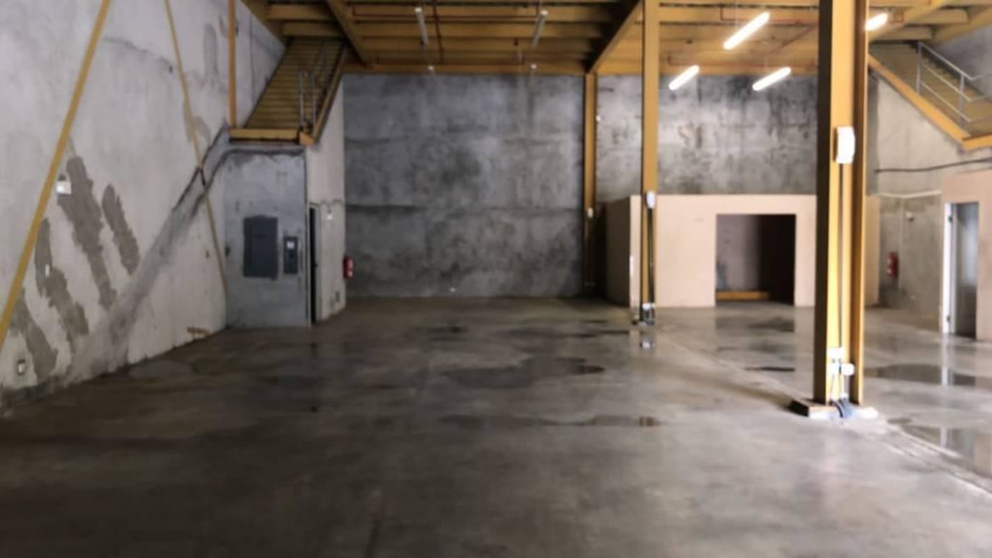 Warehouse space with yellow beams, staircase, and polished floor in Juan Díaz Panama