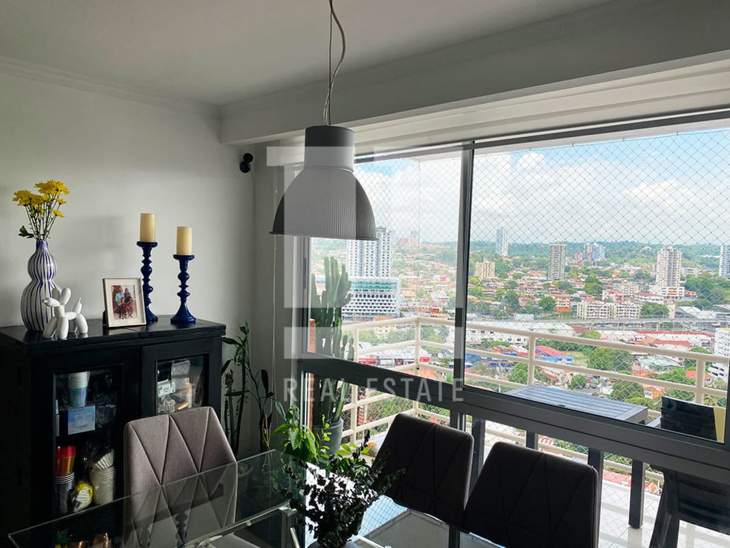 Dining area with floor-to-ceiling windows overlooking Panama City skyline in PH Sky Level