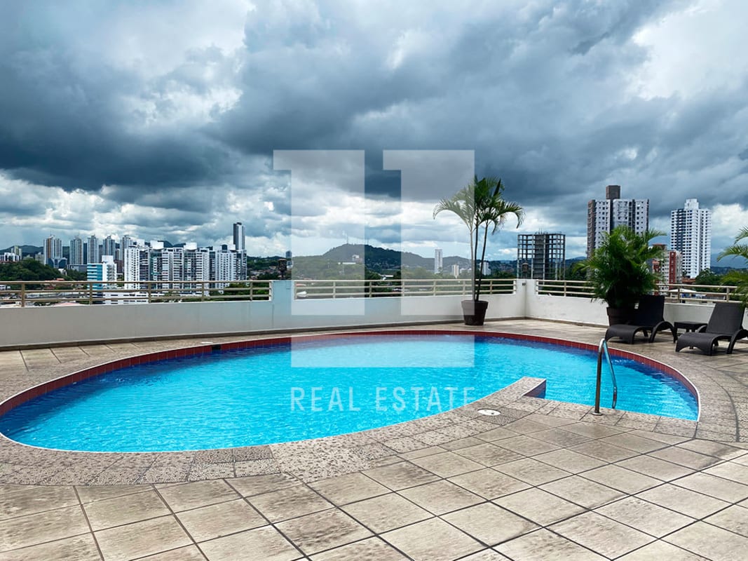 Rooftop pool with lounge chairs against panoramic skyline in PH Sky Level Hato Pintado Panama