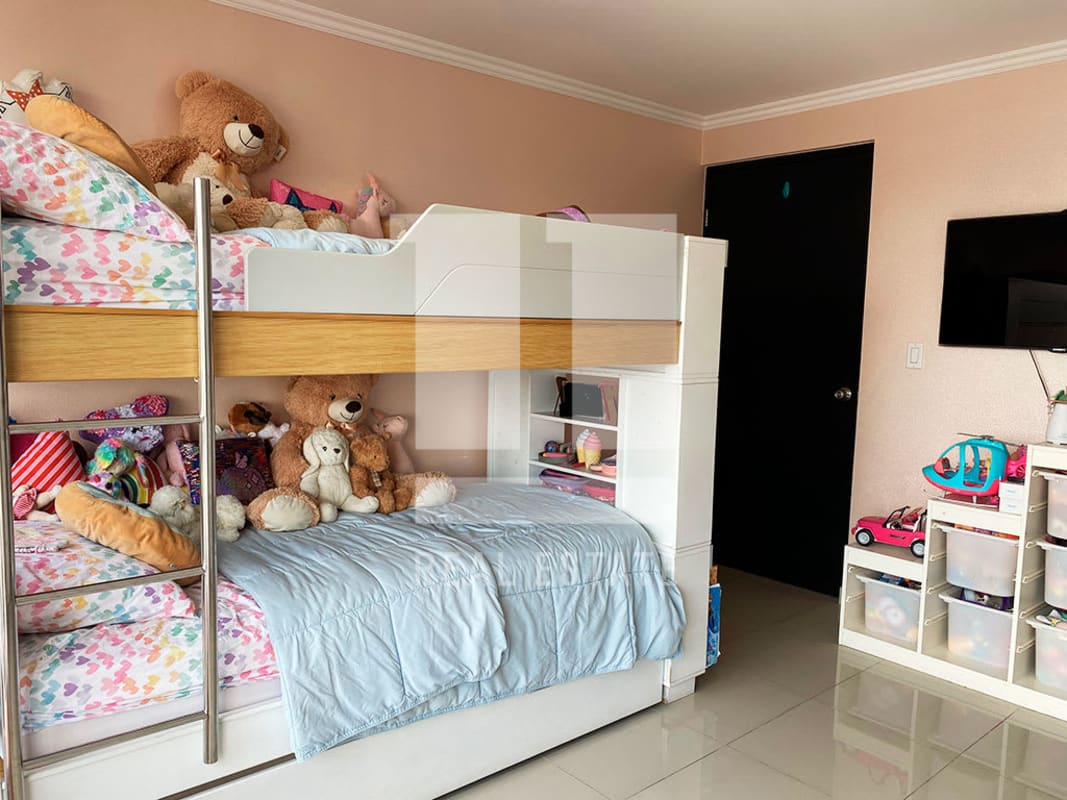 Kids room with bunk bed, city view window and built-in closet at PH Sky Level