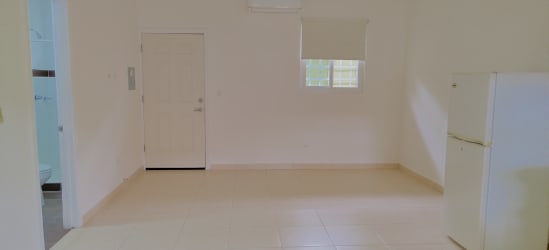Facade of multiple studio apartments with red tile roof in Rio Hato Panama