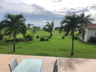 Master suite with ocean view, large windows, and ensuite bathroom in Pedasi Panama