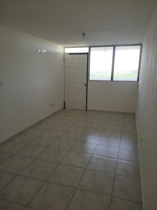 Empty minimalist living room with tiled flooring PH Residencial Llano Bonito Panama
