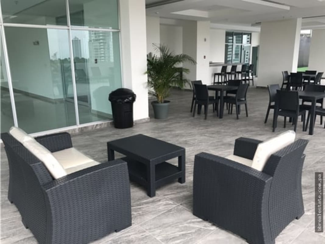 Open living room with balcony access and city view in PH Residencias del Sol Carrasquilla Panama City