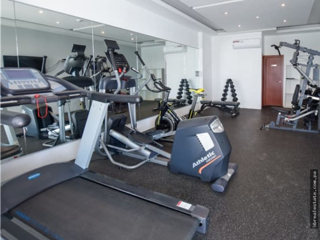 Fully equipped indoor gym with cardio and strength machines in PH Residencias del Sol Panama City