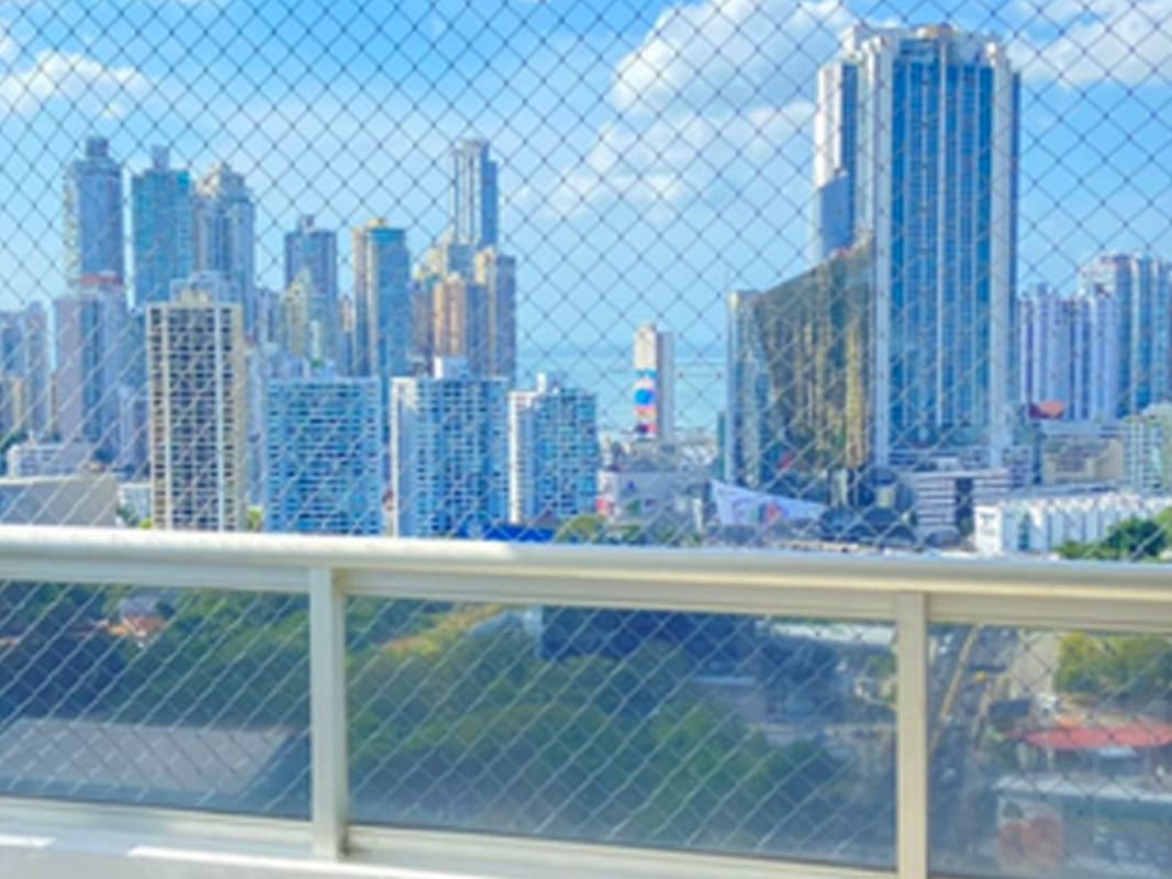 Balcony with safety netting glass railing city skyline PH Pacific Coast Panama City