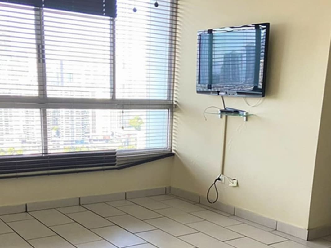 Living room with tile floors wall-mounted TV large windows blinds PH Pacific Coast Panama