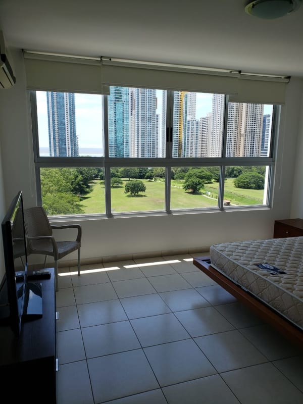 Apartment kitchen featuring granite countertops and wood cabinets in PH Vertikal, Costa del Este Panama