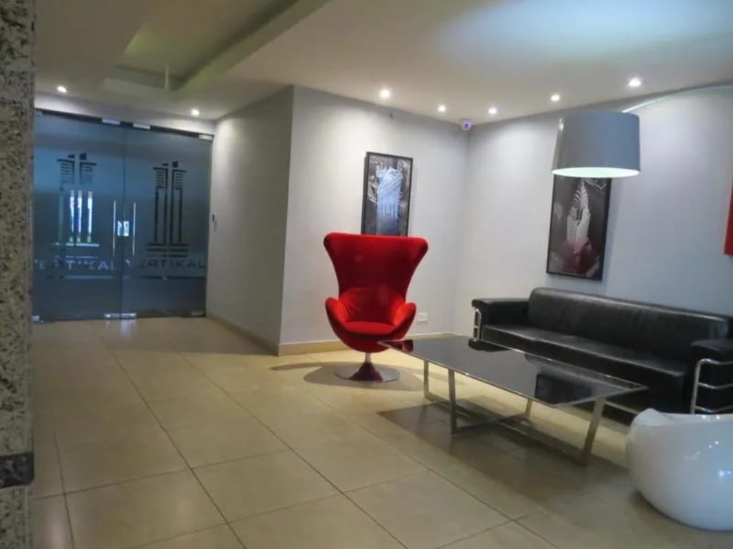 Master bedroom with bathroom and large windows at PH Vertikal in Costa del Este, Panama City