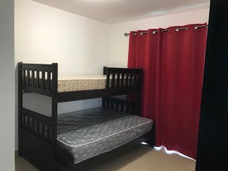 Contemporary bathroom with tiled walls and modern fixtures inside Ibiza Residences beach house in Coclé Panama