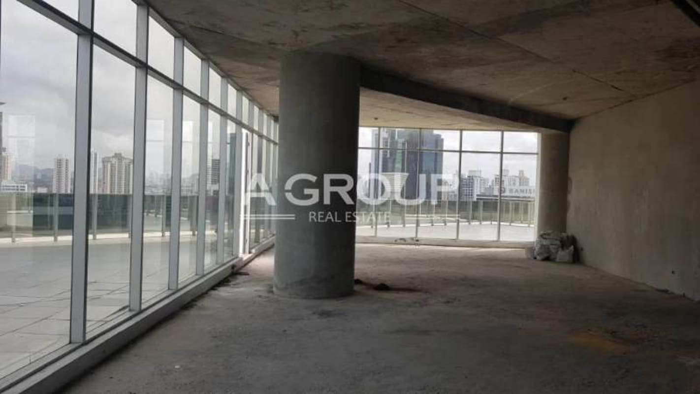 Spacious unfinished office interior with panoramic city views through large floor-to-ceiling windows at Revolution Tower Panama