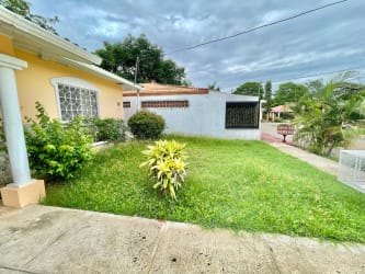 Bright empty bedroom with window, tile floors in Brisas Los Guayacanes house Chitré