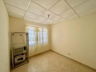 Open-plan living room with tiled floor and window in Chitré house for sale