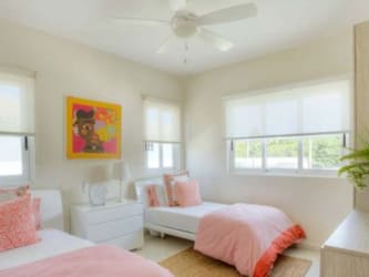 Large infinity swimming pools with ocean views surrounded by palm trees in Bijao Beach Residences