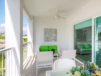Covered balcony with seating, ceiling fan at Bijao Beach Club PH Gatun Panama