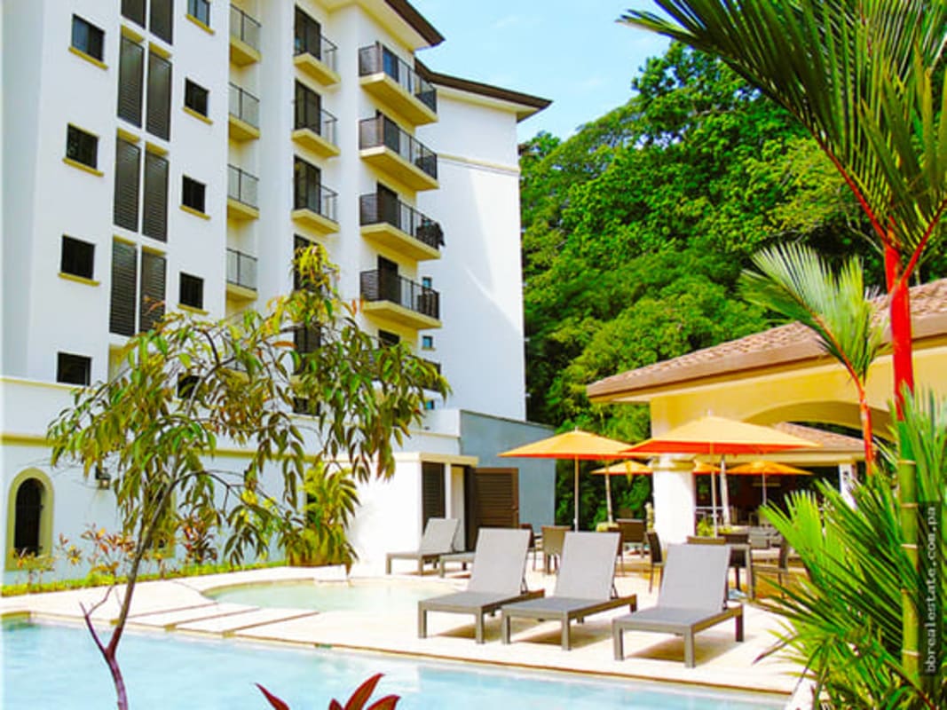 Covered dining and lounge area by pool at PH Embassy Village Clayton Panama