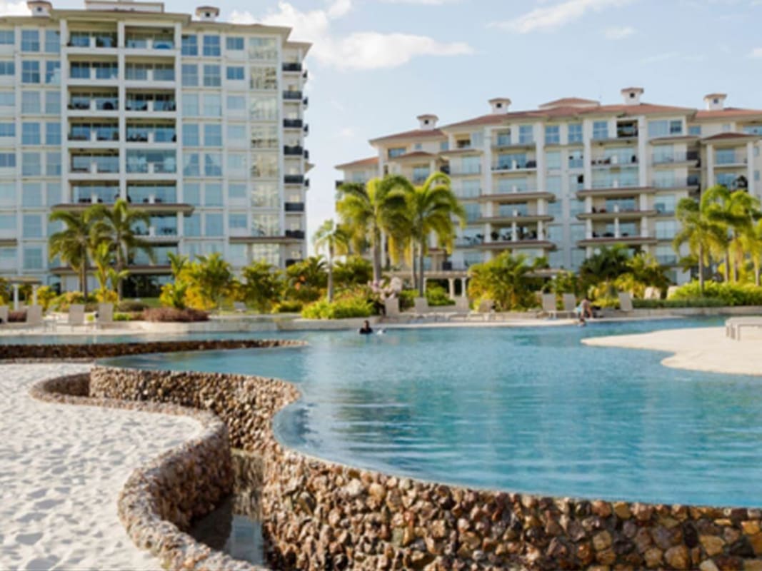 Towering condominiums beachfront pool palm trees PH Pinnacle The Reserve Santa Maria Panama
