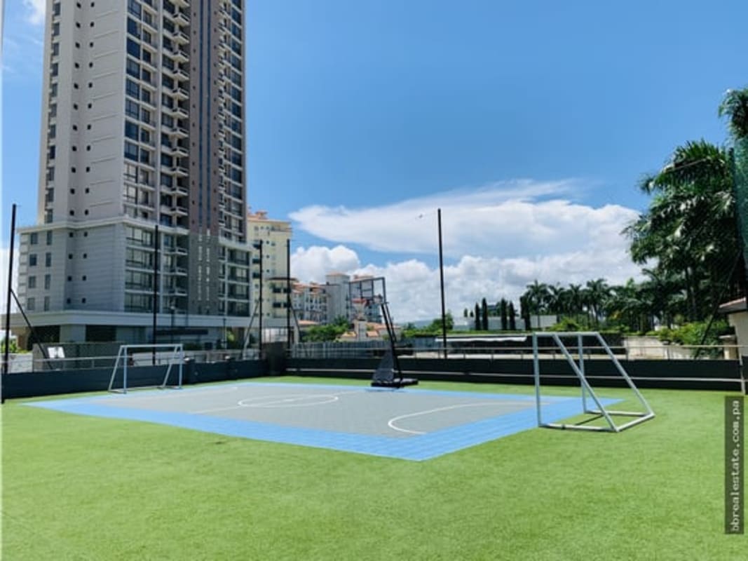 Outdoor multi-sports court with artificial turf and high-rise PH Valery Point in Santa María Panama