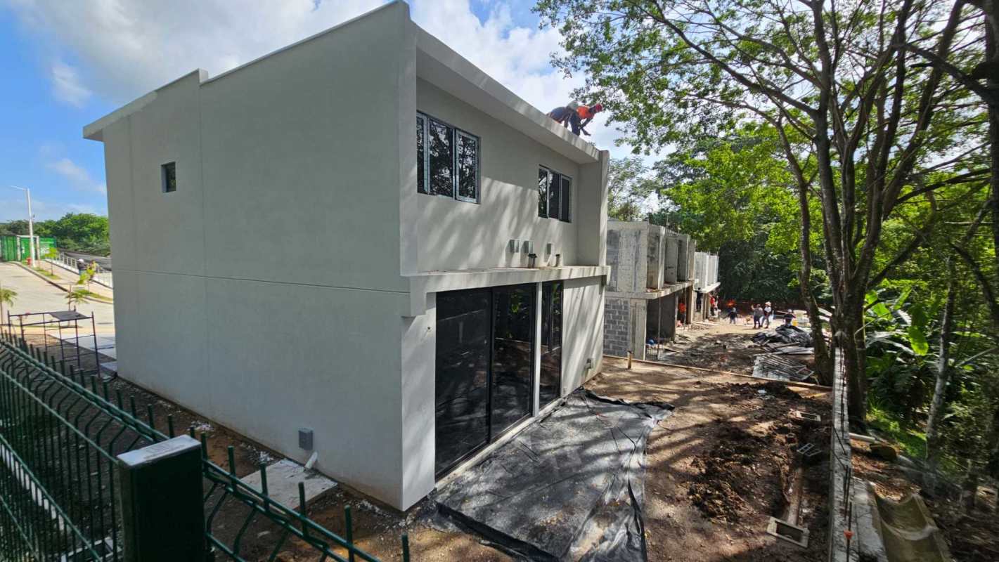 Spacious interior of modern duplex featuring marble flooring and large sliding doors overlooking garden Clayton Panama
