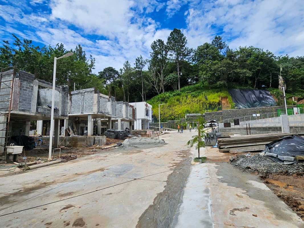 Bright unfinished bedroom in duplex home with marble flooring and large window overlooking trees in Clayton