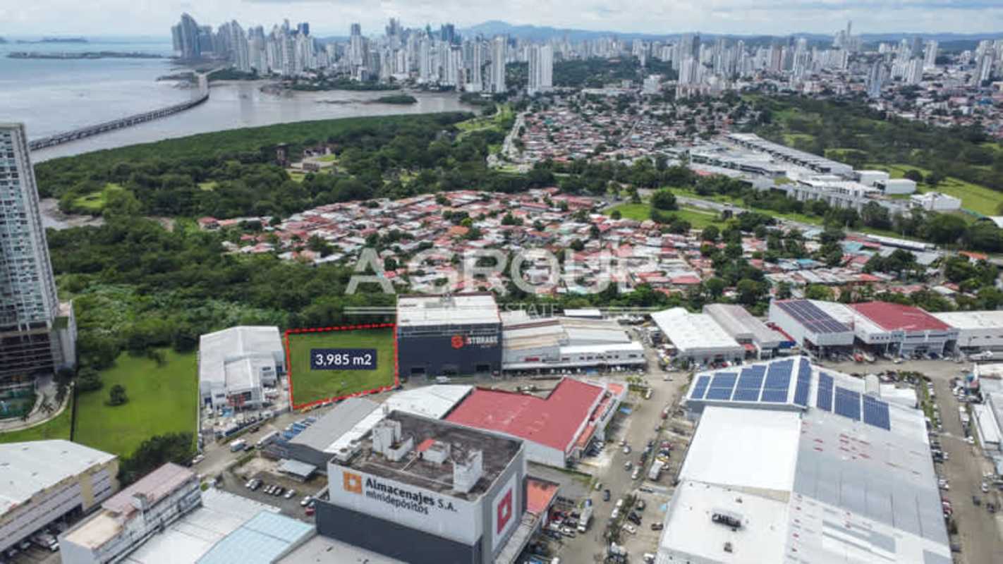 Fenced vacant grassy lot within industrial and commercial Costa del Este sector Panama City