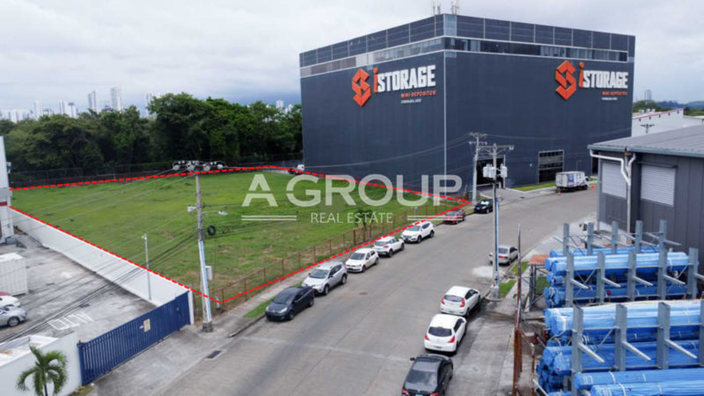 Vacant fenced commercial real estate lot with skyline in industrial park Costa del Este Panama