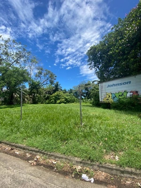 Vacant corner lot with trees, sidewalk and trailer in Diablo Ancón Panama City